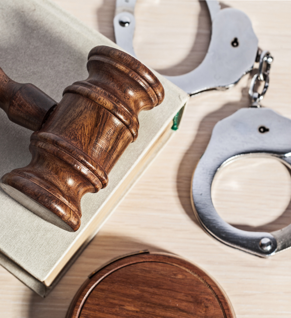 Judge's gavel and handcuffs sit on table