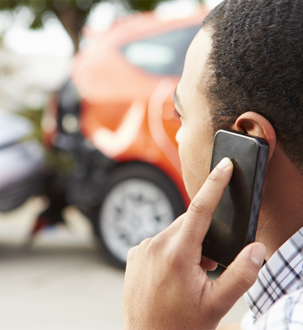 Person on phone after car accident