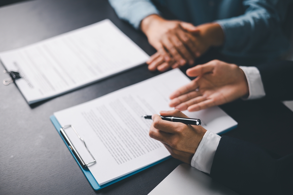 Lawyer reviewing contract with client