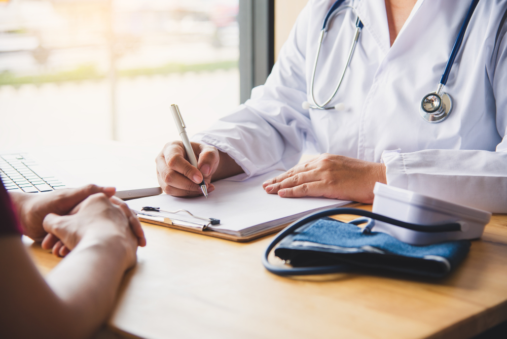 Doctor going over insurance paperwork with patient
