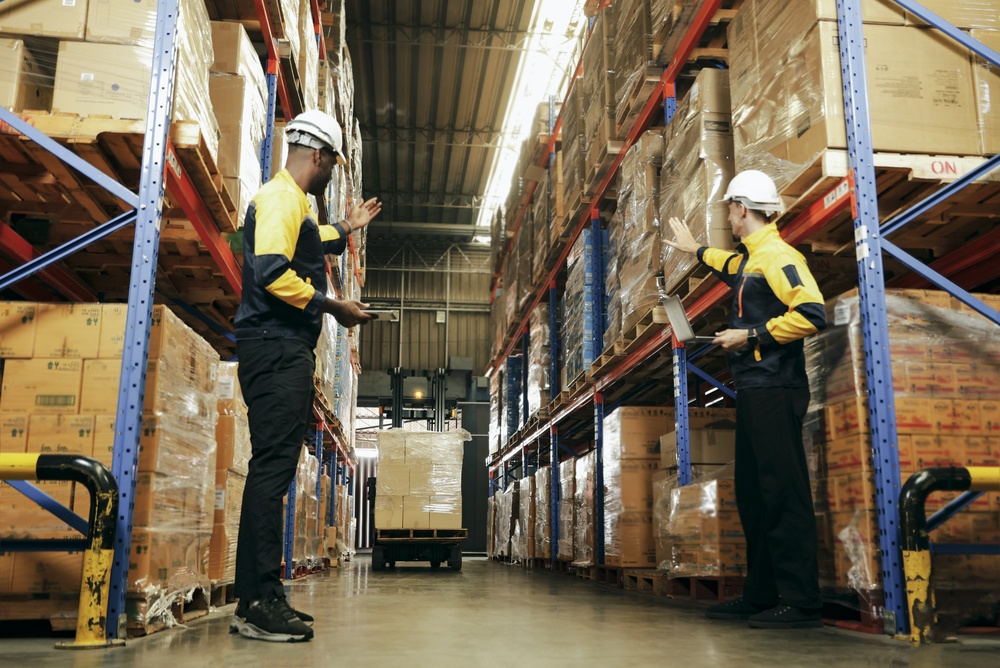 Warehouse employees safely guiding forklift