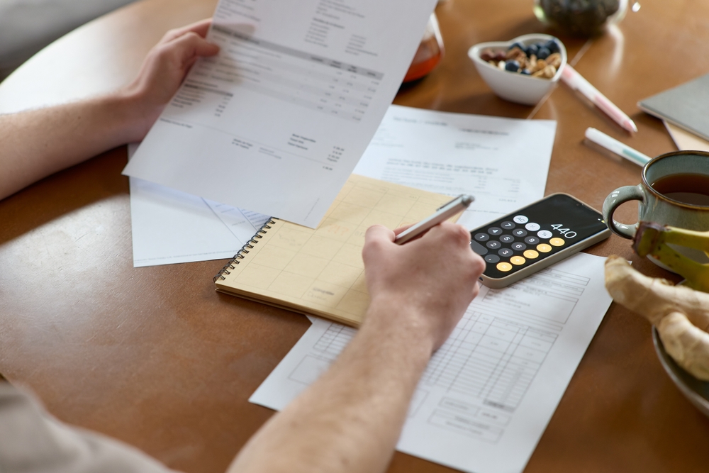 Worker reviewing pay stubs in order to calculate potential lost wages