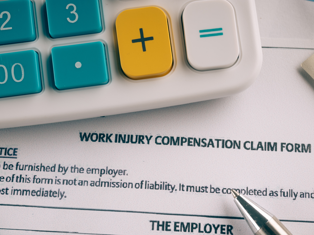 Stylized image of a worker injury form and calculator